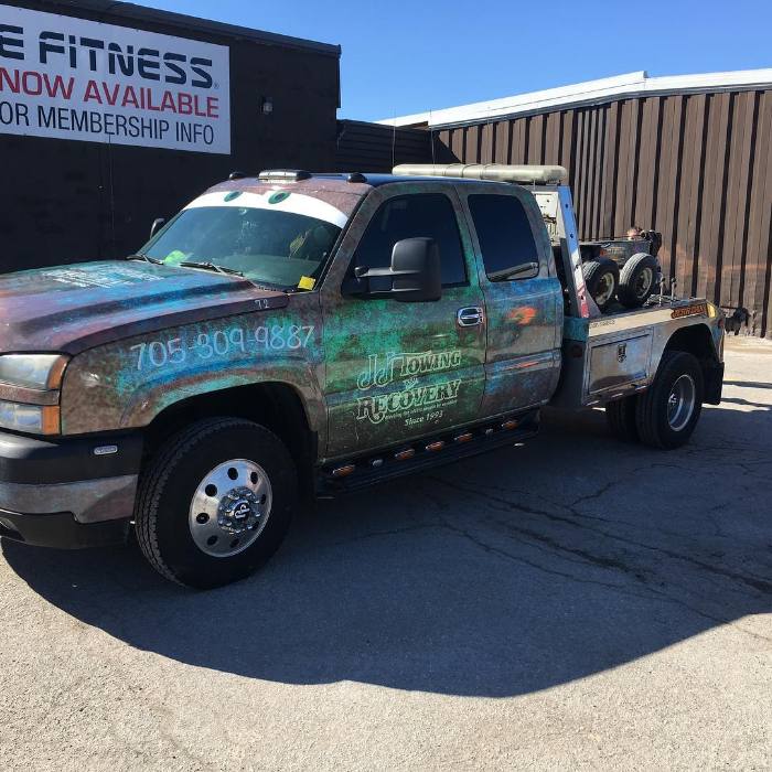 Wrapped J&J towing truck outside